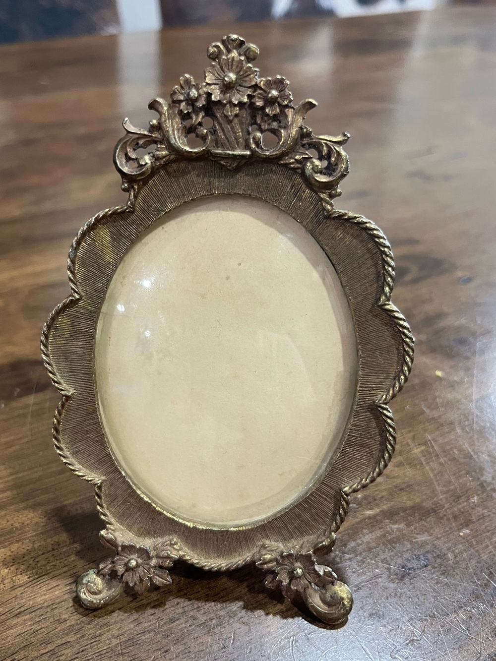 Vintage gold plated oval frame with glass.